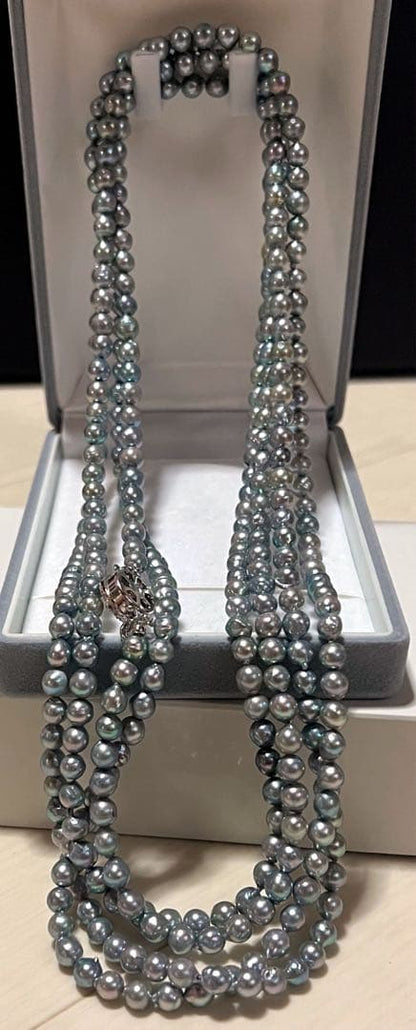 Akoya pearl long necklace in blue silver color made with pearls and silver shown on a white background