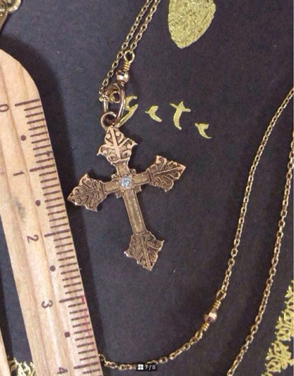 Agatte K10 gold pendant top with antique leaf motif cross and center diamond weighing 1.79 grams