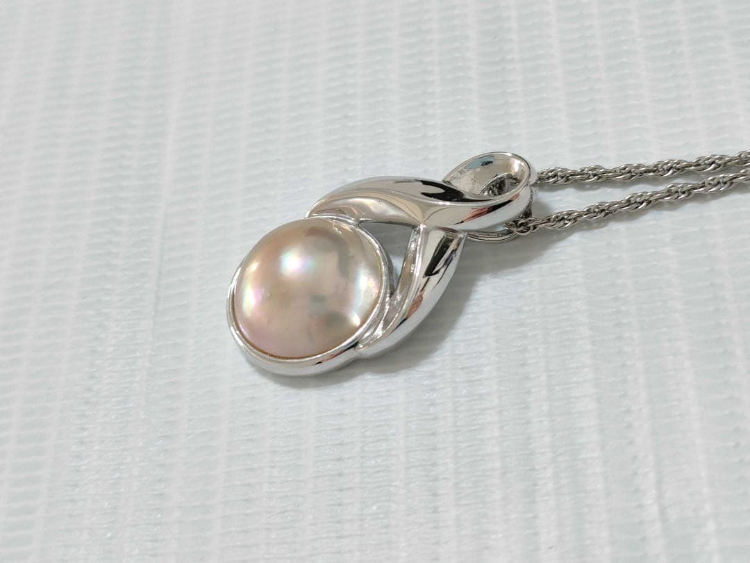 Tasaki Pearl Necklace with curved design and solid Mabe pearl pendant on engraved clasp closure
