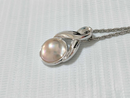 Tasaki Pearl Necklace with curved design and solid Mabe pearl pendant on engraved clasp closure