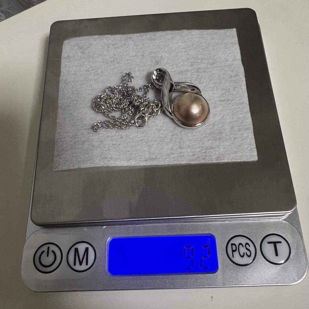 Tasaki Pearl Necklace with curved design and solid Mabe pearl pendant on engraved clasp closure