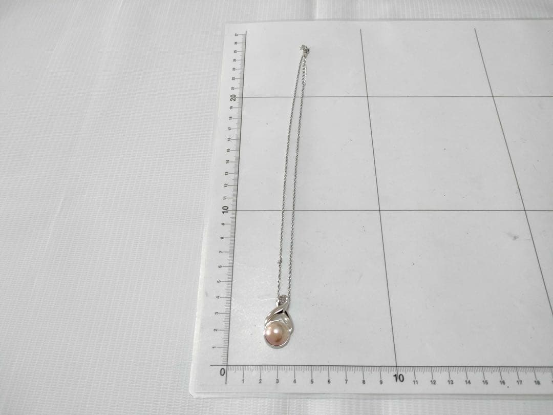 Tasaki Pearl Necklace with curved design and solid Mabe pearl pendant on engraved clasp closure