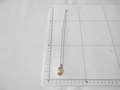 Tasaki Pearl Necklace with curved design and solid Mabe pearl pendant on engraved clasp closure