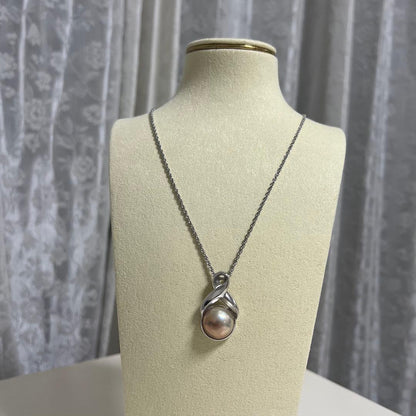 Tasaki Pearl Necklace with curved design and solid Mabe pearl pendant on engraved clasp closure