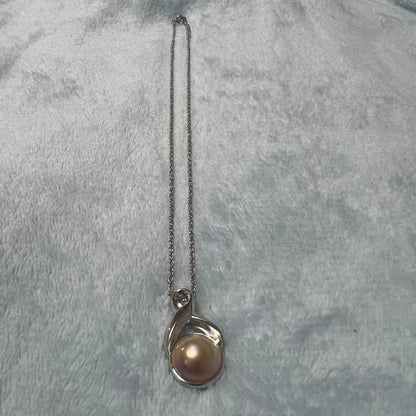 Tasaki Pearl Necklace with curved design and solid Mabe pearl pendant on engraved clasp closure