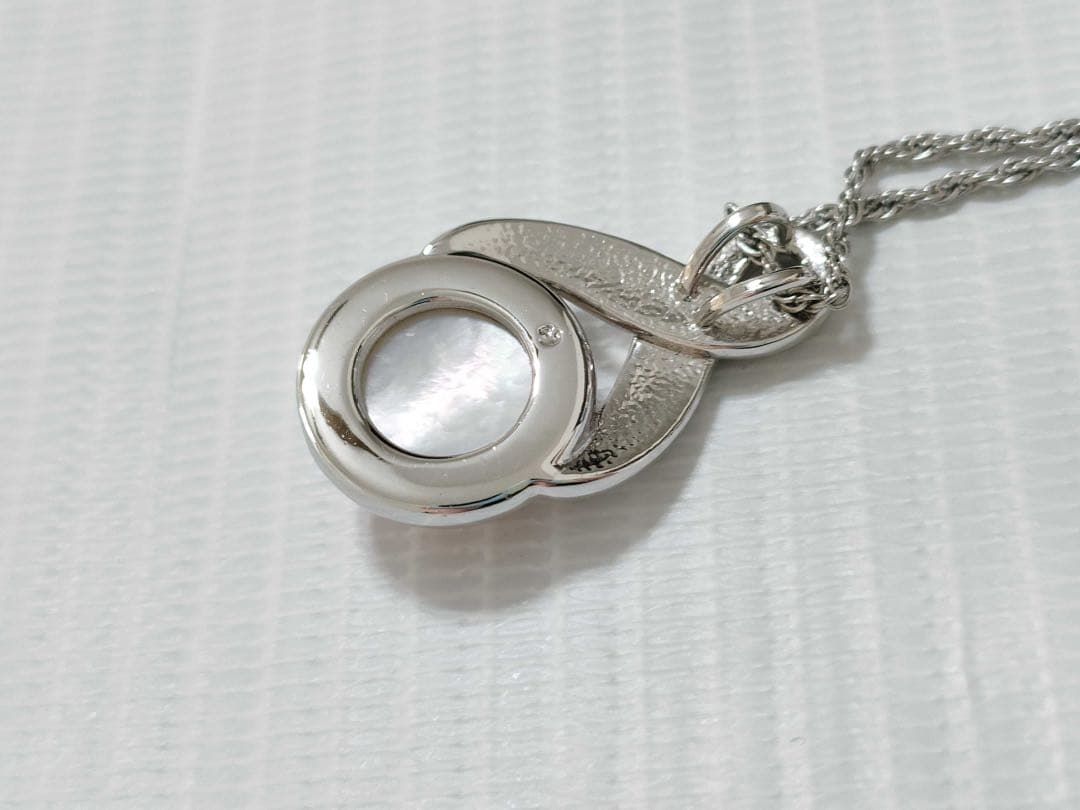 Tasaki Pearl Necklace with curved design and solid Mabe pearl pendant on engraved clasp closure