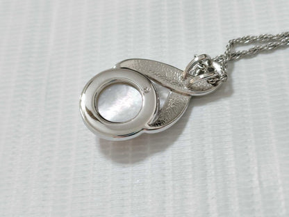 Tasaki Pearl Necklace with curved design and solid Mabe pearl pendant on engraved clasp closure