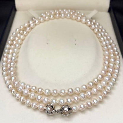 Long 121cm triple strand Akoya pearl necklace with 7.5mm pearls and silver clasp