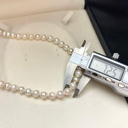 Long 121cm triple strand Akoya pearl necklace with 7.5mm pearls and silver clasp