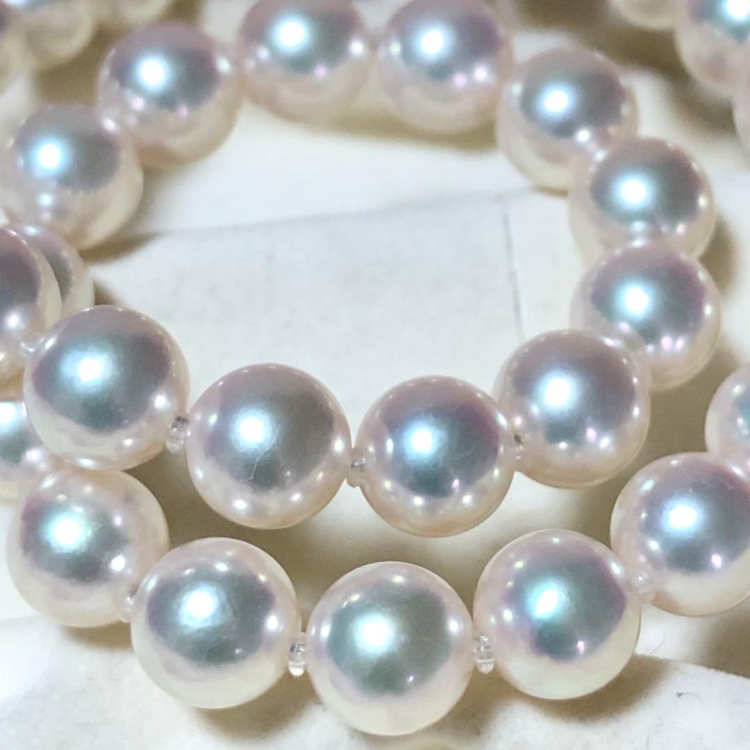 Akoya pearl necklace with 7mm white pearls and silver clasp laid flat showing length and bead size