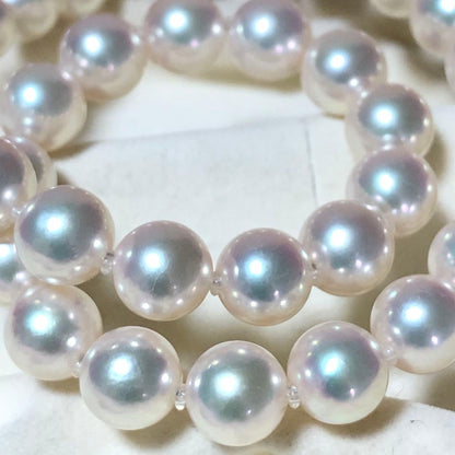 Akoya pearl necklace with 7mm white pearls and silver clasp laid flat showing length and bead size