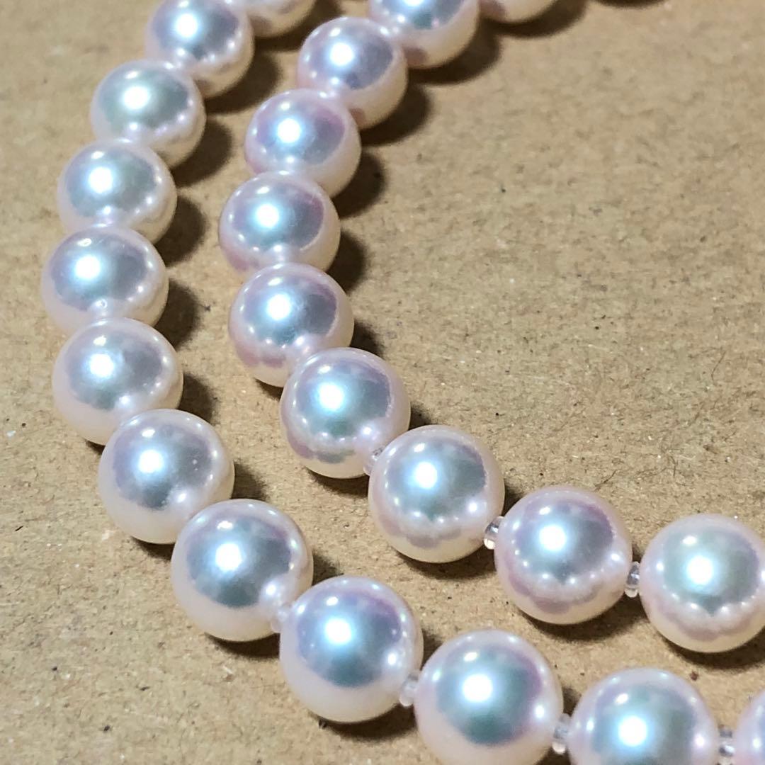 Akoya pearl necklace with 7mm white pearls and silver clasp laid flat showing length and bead size