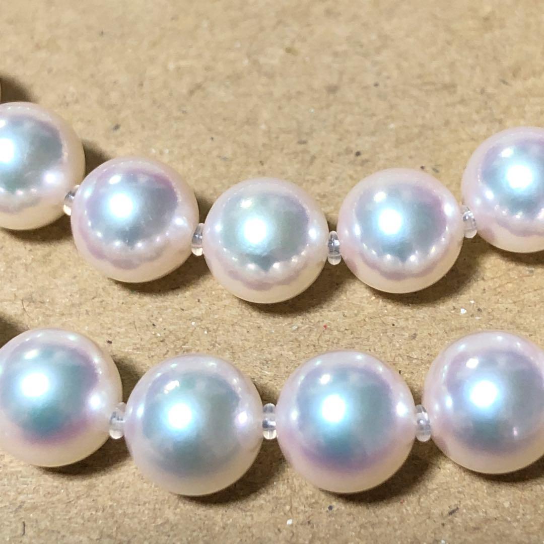 Akoya pearl necklace with 7mm white pearls and silver clasp laid flat showing length and bead size
