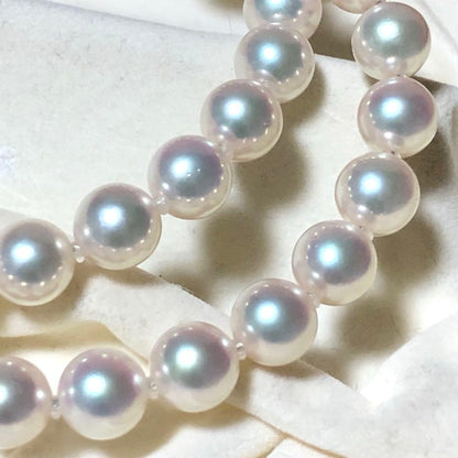 Akoya pearl necklace with 7mm white pearls and silver clasp laid flat showing length and bead size