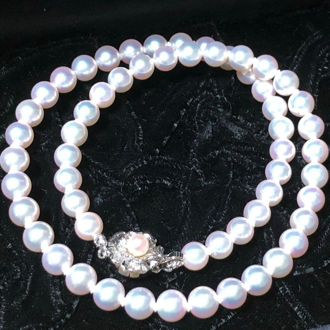 Akoya pearl necklace with 7mm white pearls and silver clasp laid flat showing length and bead size