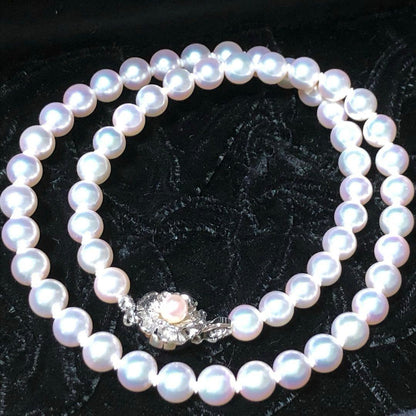 Akoya pearl necklace with 7mm white pearls and silver clasp laid flat showing length and bead size
