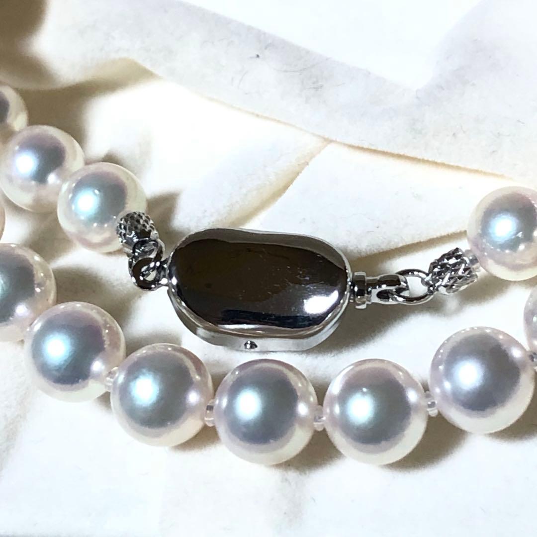 Akoya pearl necklace with 7mm white pearls and silver clasp laid flat showing length and bead size