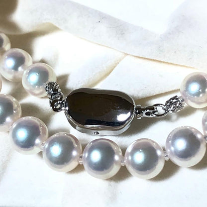 Akoya pearl necklace with 7mm white pearls and silver clasp laid flat showing length and bead size