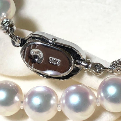 Akoya pearl necklace with 7mm white pearls and silver clasp laid flat showing length and bead size