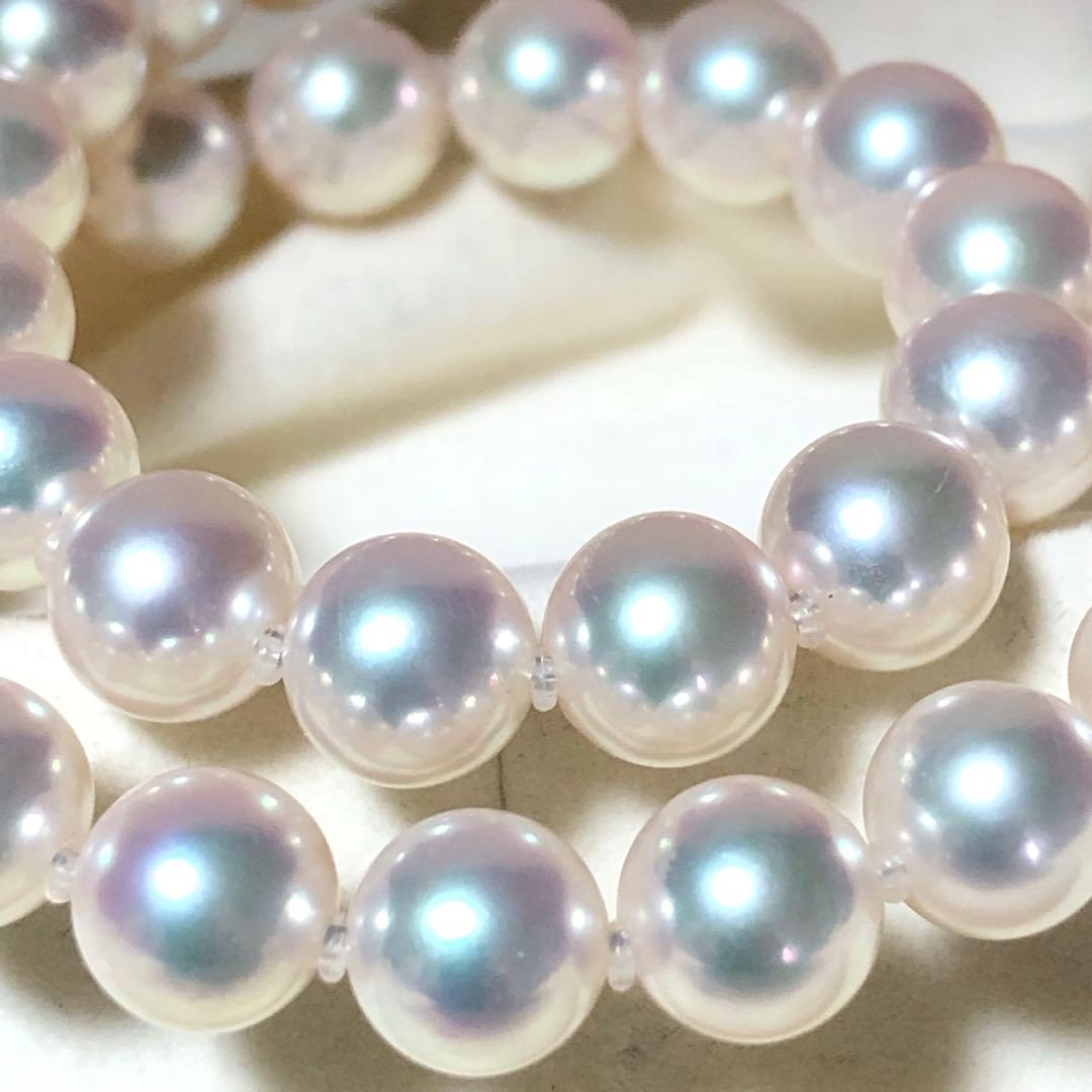 Akoya pearl necklace with 7mm white pearls and silver clasp laid flat showing length and bead size