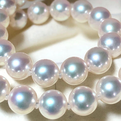 Akoya pearl necklace with 7mm white pearls and silver clasp laid flat showing length and bead size