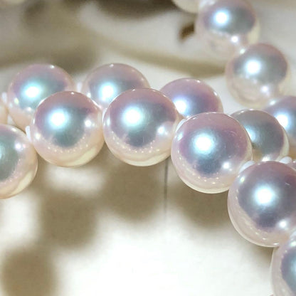 Akoya pearl necklace with 7mm white pearls and silver clasp laid flat showing length and bead size