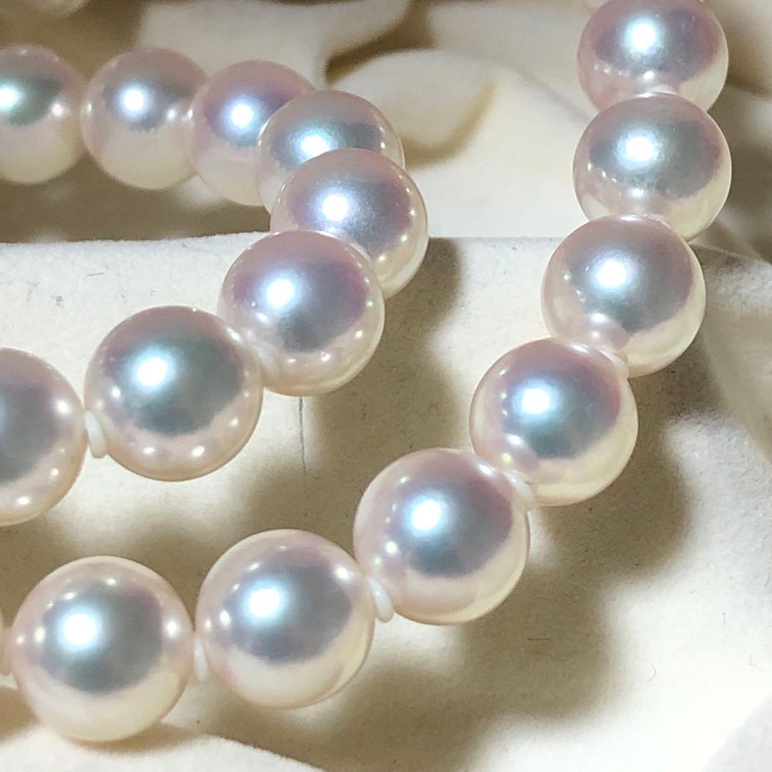 Akoya pearl necklace with 7mm white pearls and silver clasp laid flat showing length and bead size
