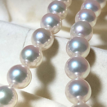 Akoya pearl necklace with 7mm white pearls and silver clasp laid flat showing length and bead size