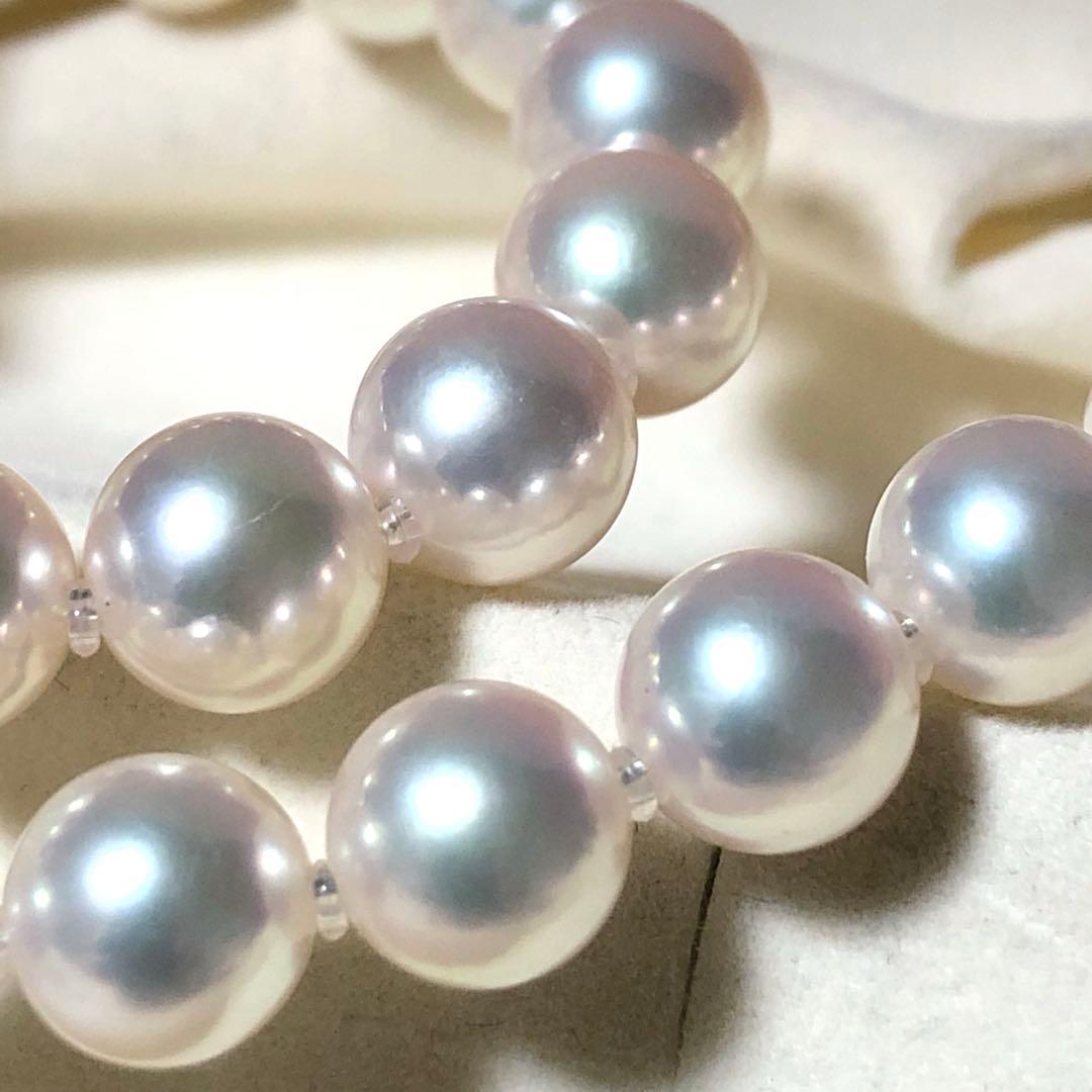 Akoya pearl necklace with 7mm white pearls and silver clasp laid flat showing length and bead size