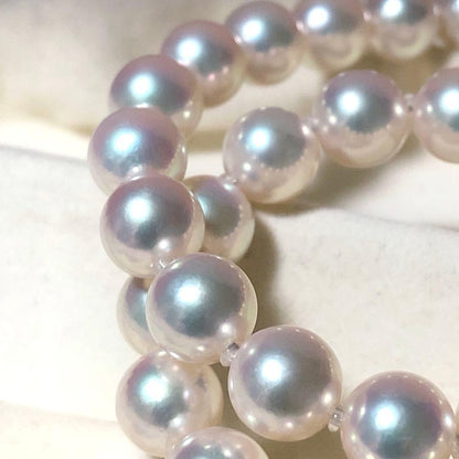 Akoya pearl necklace with 7mm white pearls and silver clasp laid flat showing length and bead size