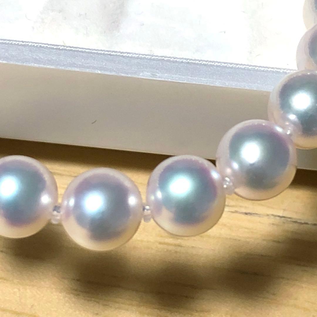 Akoya pearl necklace with 7mm white pearls and silver clasp laid flat showing length and bead size
