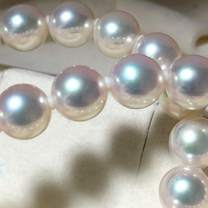 Akoya pearl necklace with 7mm white pearls and silver clasp laid flat showing length and bead size