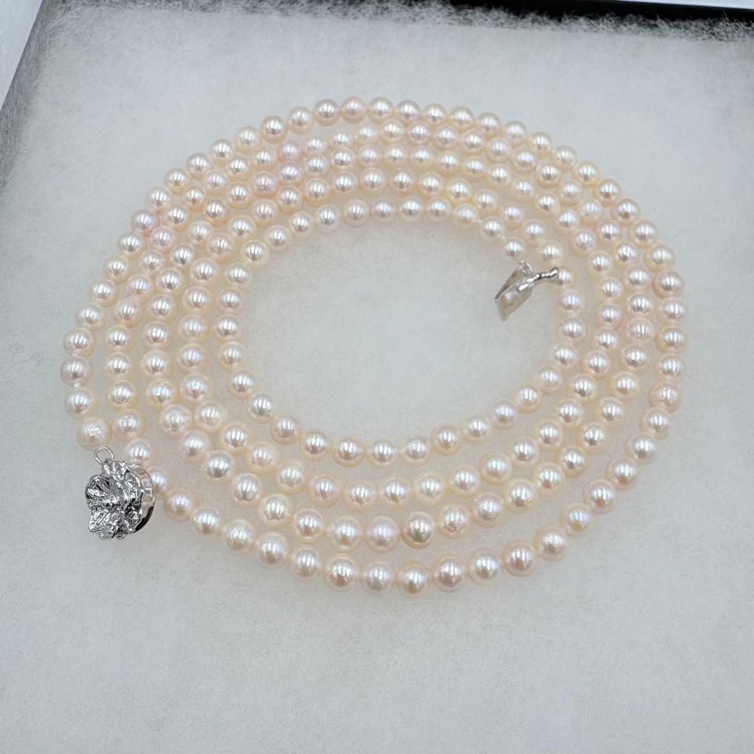 Long Akoya pearl necklace measuring 126cm with round 6.5mm white pearls on display