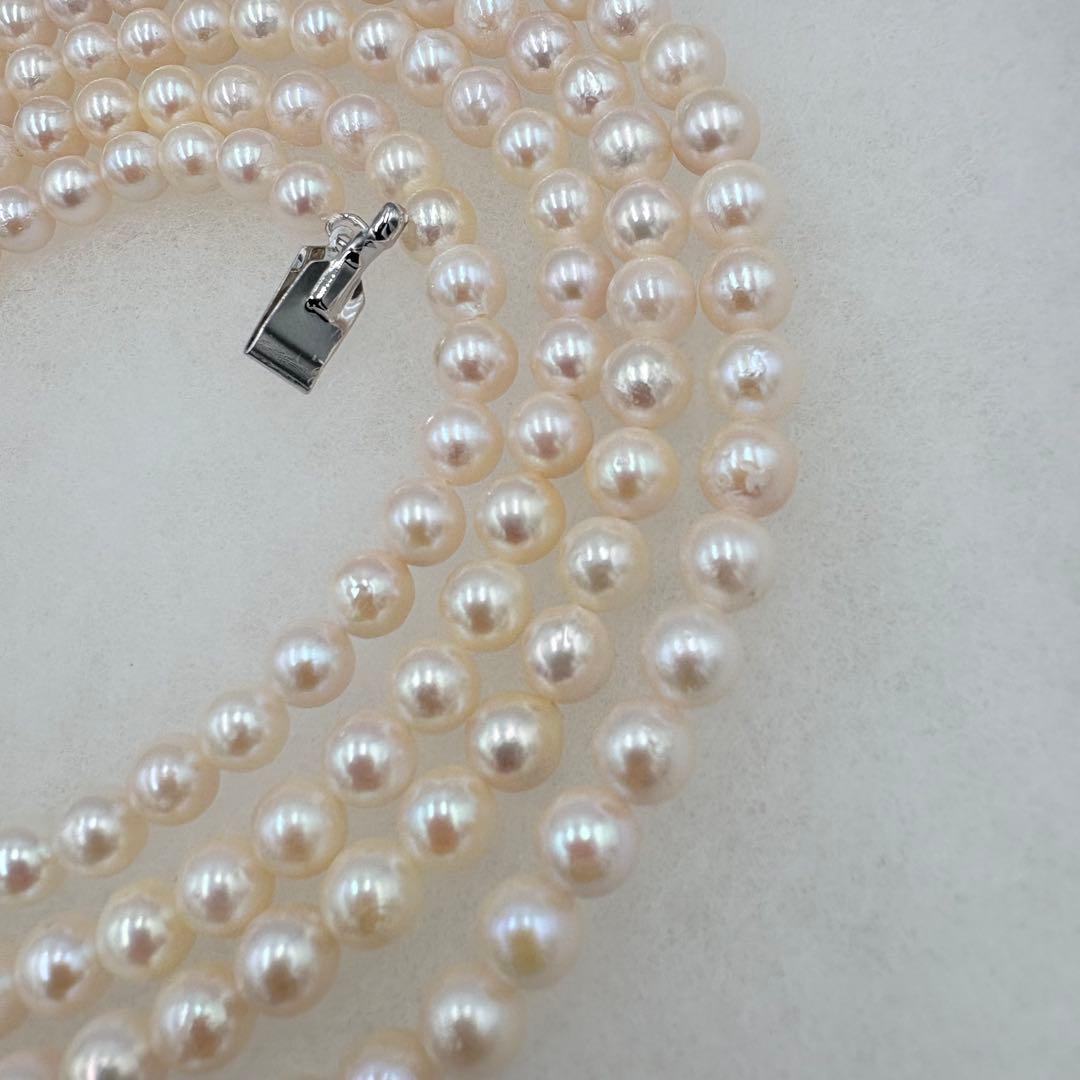 Long Akoya pearl necklace measuring 126cm with round 6.5mm white pearls on display