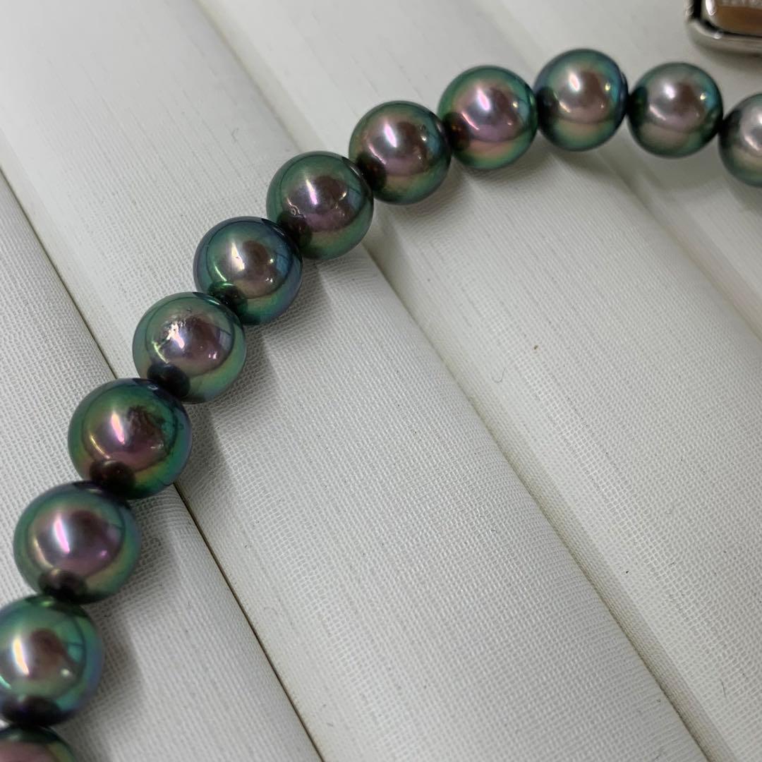 Close-up of Akoya dyed pearl necklace with 7-7.5mm pearls and silver clasp on white background