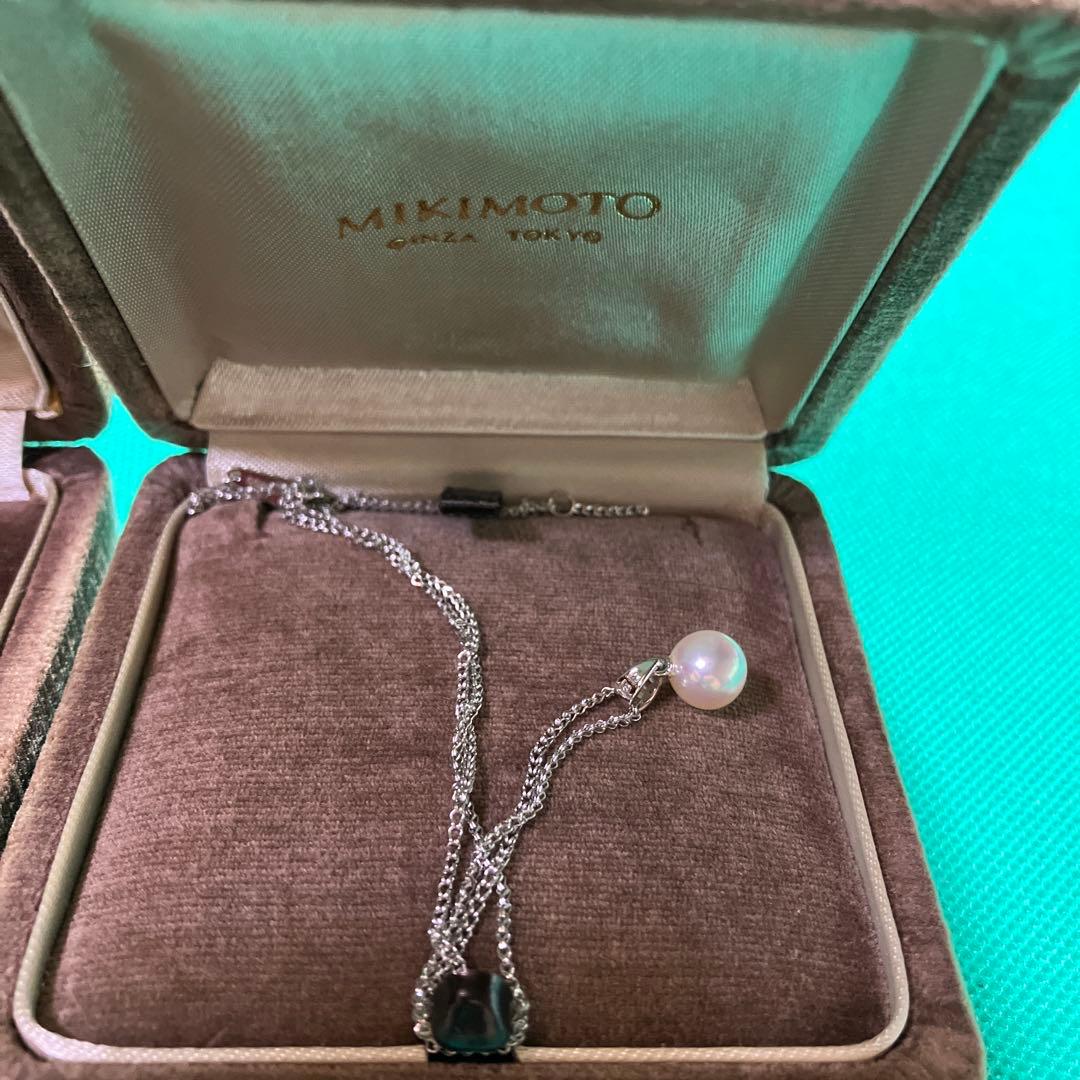 MIKIMOTO simple pearl necklace with silver chain and adjustable length shown on white background