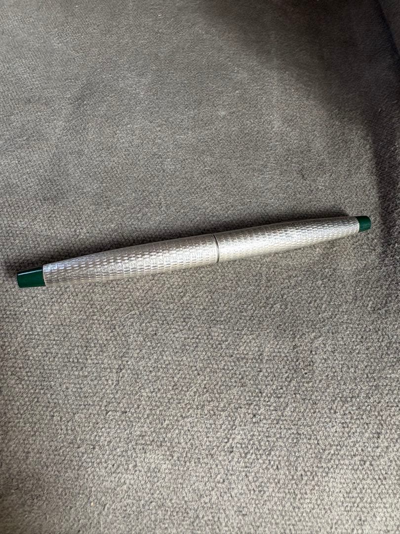 Pilot 14k 585 fountain pen with silver grid pattern body and green accents showing slight dent
