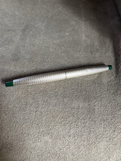 Pilot 14k 585 fountain pen with silver grid pattern body and green accents showing slight dent