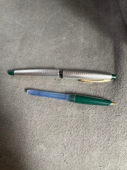 Pilot 14k 585 fountain pen with silver grid pattern body and green accents showing slight dent