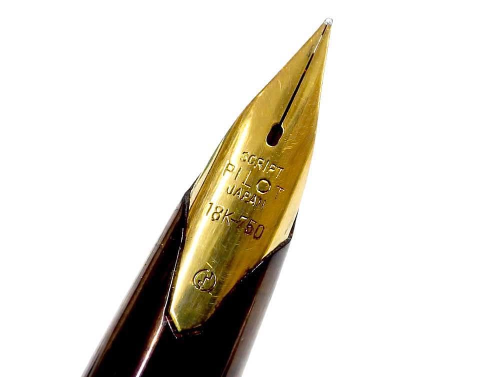 Pilot fountain pen with 18K gold nib and black metal body, decorated with gold accents