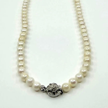 Akoya real pearl necklace with 6.4-6.8mm white pearls and silver clasp on a white background