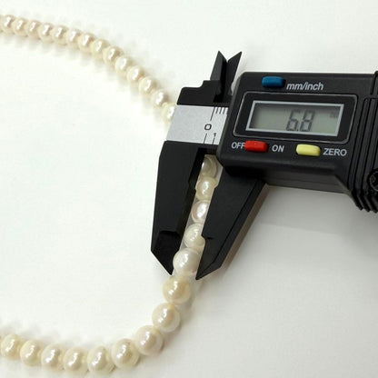 Akoya real pearl necklace with 6.4-6.8mm white pearls and silver clasp on a white background