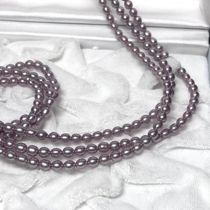 TASAKI baby pearl necklace with rare purple natural pearls, three strands, displayed with box