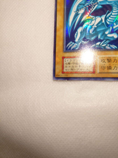 Yugioh Blue-Eyes White Dragon Early Ultra Rare trading card in protective sleeve and hard case
