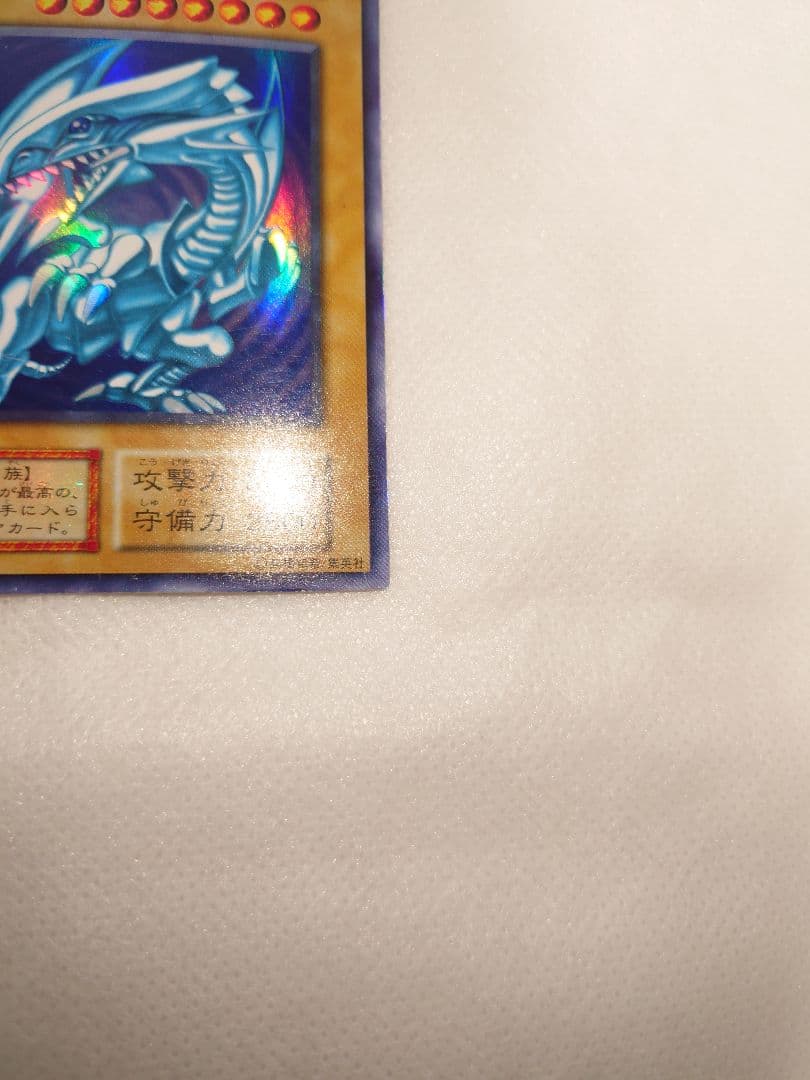 Yugioh Blue-Eyes White Dragon Early Ultra Rare trading card in protective sleeve and hard case