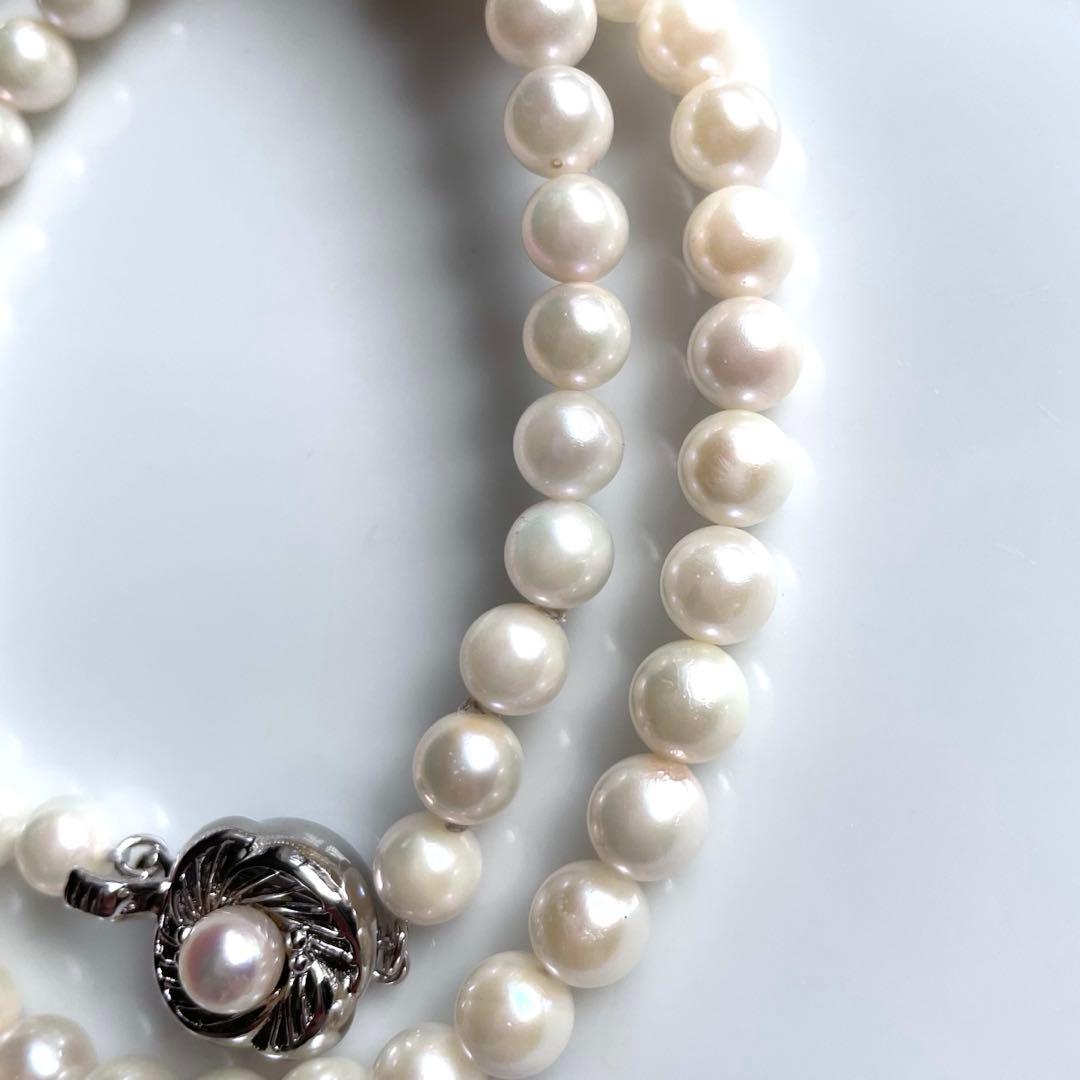 Akoya pearl necklace with white 6.0 to 6.5mm pearls and silver clasp on a white background