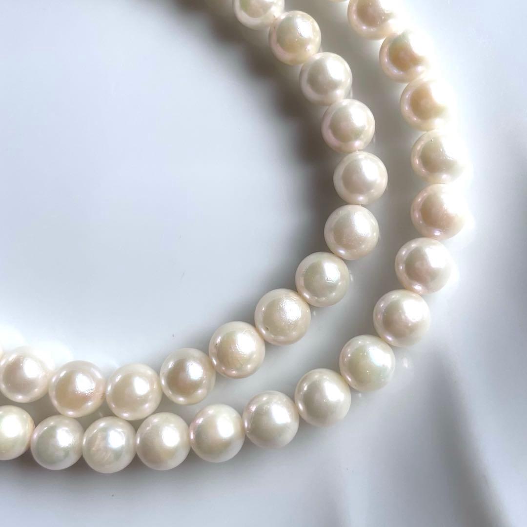 Akoya pearl necklace with white 6.0 to 6.5mm pearls and silver clasp on a white background