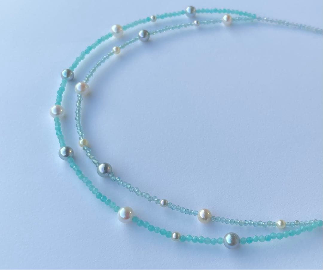 Akoya pearl layered necklace with 19 pearls in sea and sky colors showcasing transparency and unique design