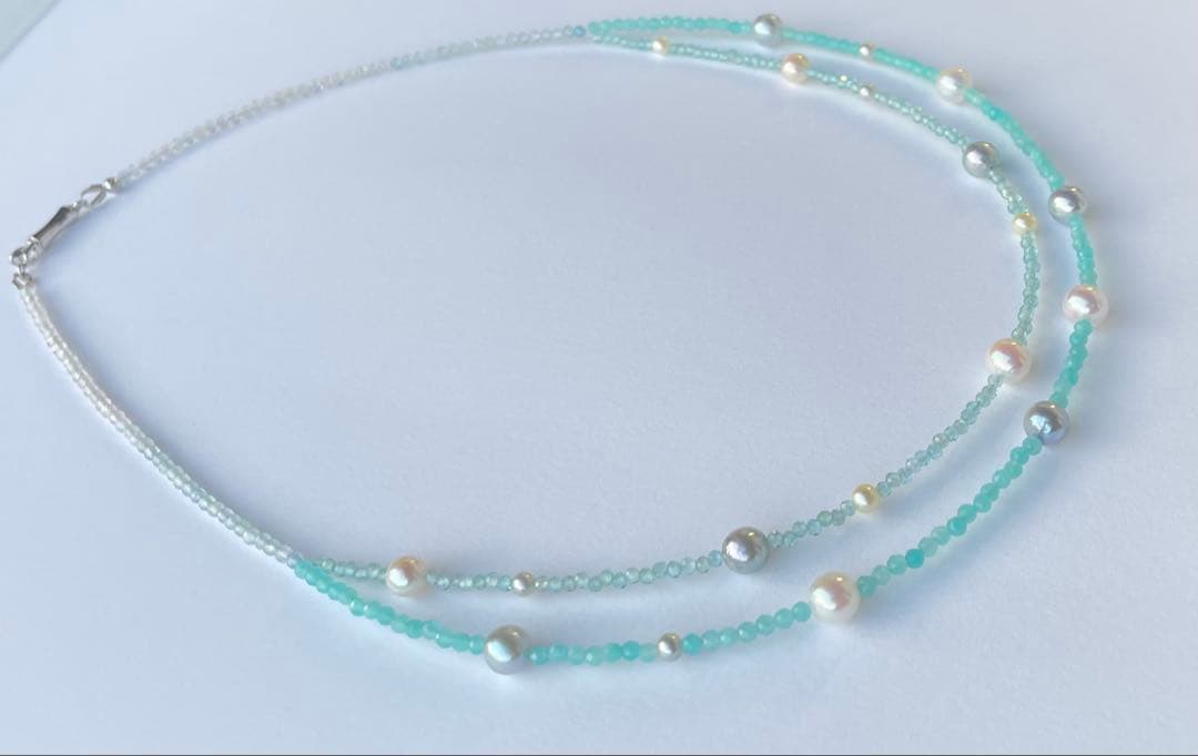 Akoya pearl layered necklace with 19 pearls in sea and sky colors showcasing transparency and unique design