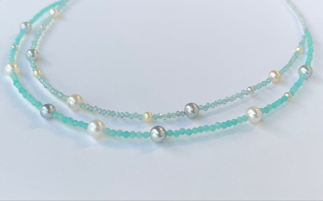 Akoya pearl layered necklace with 19 pearls in sea and sky colors showcasing transparency and unique design